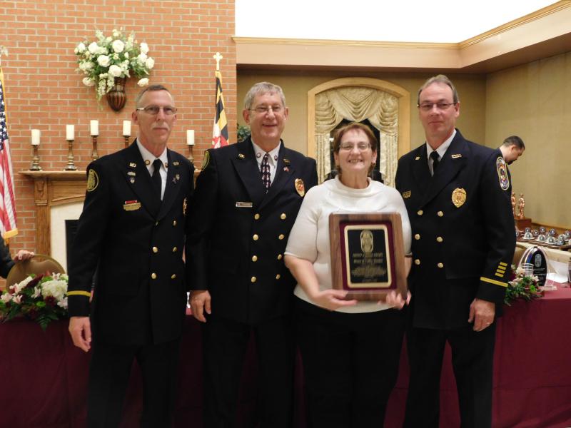 Bruce and Kathy Theden receiving a well deserved award for fire prevention from the President and Fire Chief