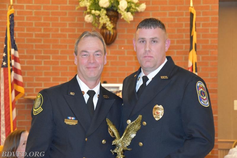 Outgoing Fire Chief Joe Gould receiving parting gift's from incoming Chief Robert Wahrenbrock.